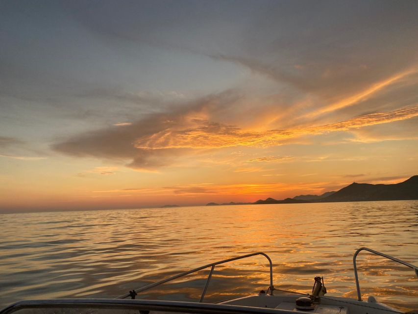 Dubrovnik: Romantic Sunset Cruise & Cave Visit with a Local - Setting out beneath the city walls