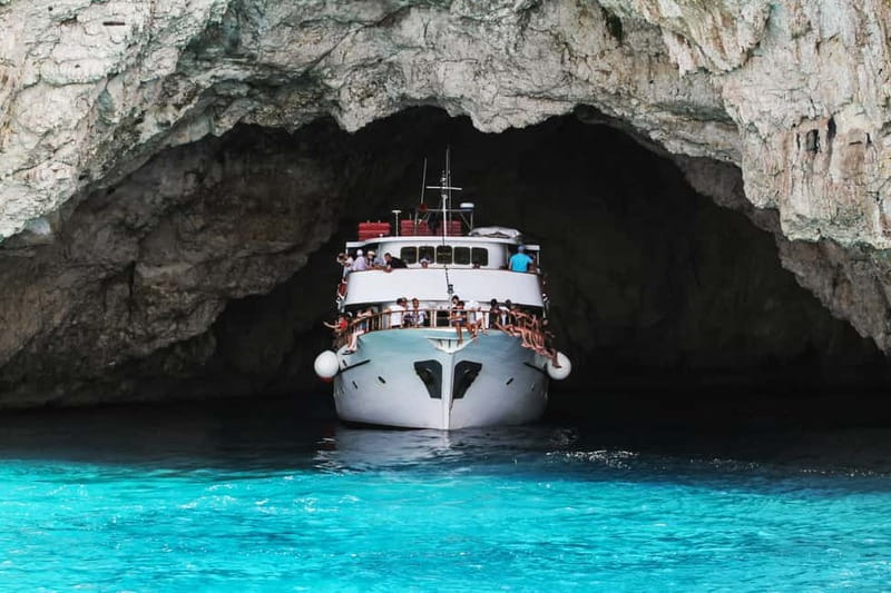 From Corfu: Day Cruise to Paxos, Antipaxos, & the Blue Caves - Entering the Blue Caves by boat