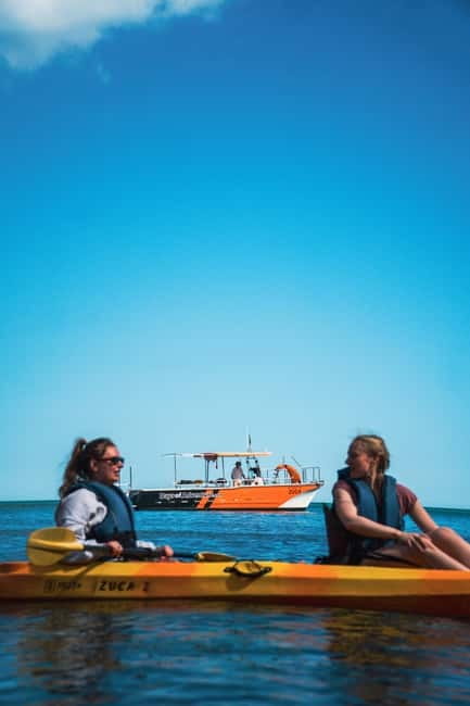From Lagos: Ponta da Piedade Caves Kayak Tour from Catamaran - Sliding into the kayak at Ponta da Piedade