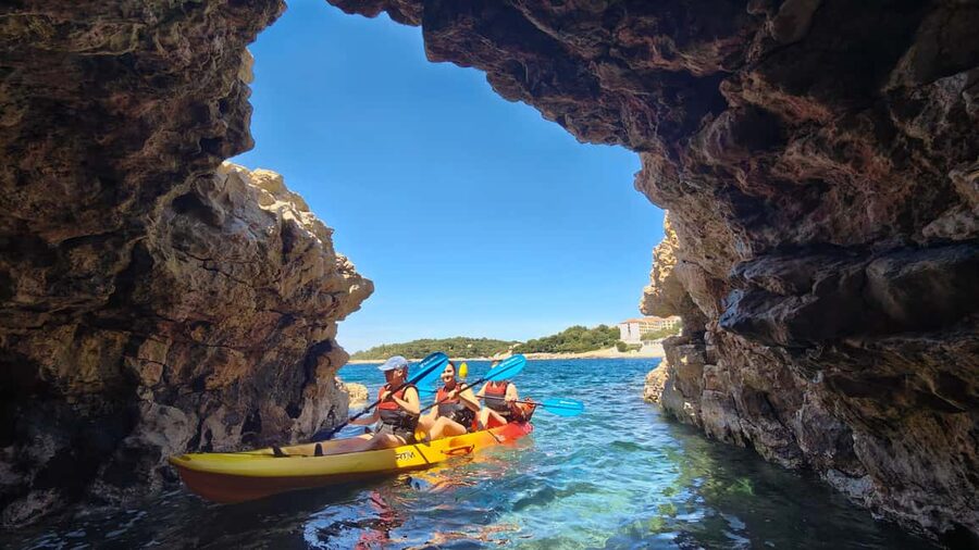 Pula: Cave Kayak Tour, Snorkeling and Island Jumping - Entering the pigeon cave