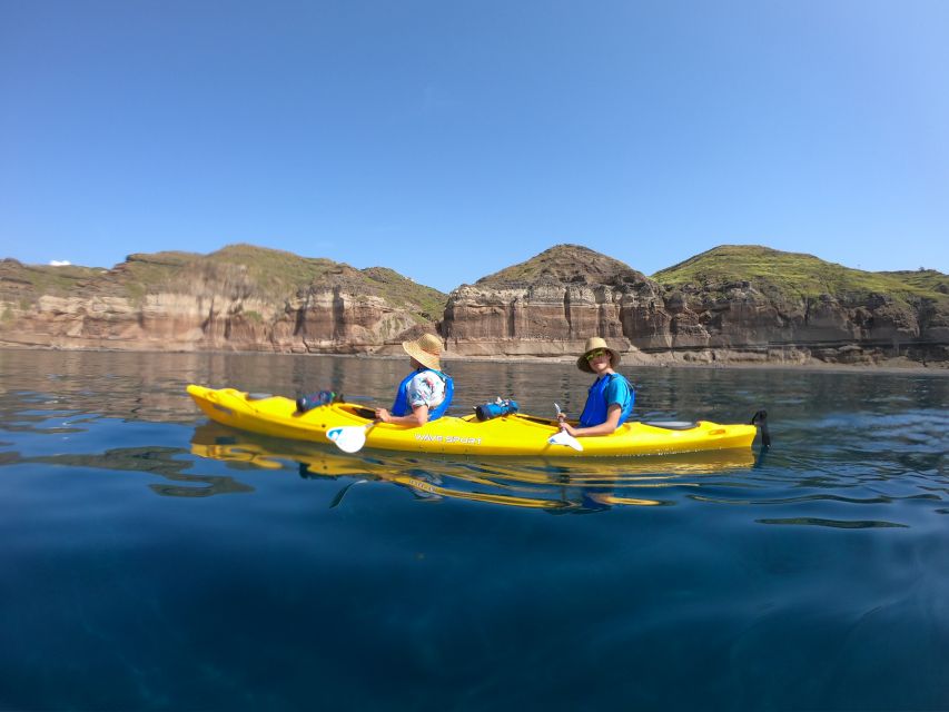 Santorini: Sea Caves Kayak Trip with Snorkeling and Picnic - Paddling into Santorini’s blue-lit sea caves
