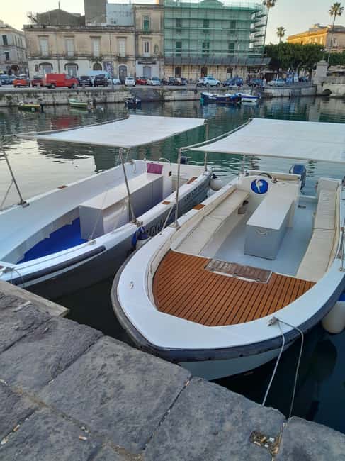 Siracusa: Ortigia Boat Tour with Marine Grotto & Snorkeling - Leaving Siracusa beneath the Umbertino Bridge